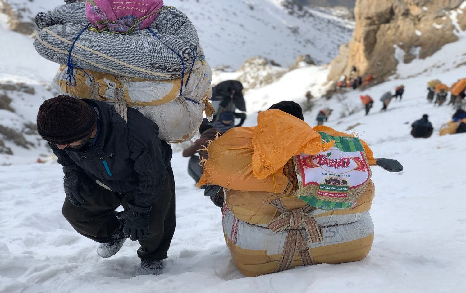 Kolbars carrying large loads on the slope of Tata Mountain, Hawraman on February 2019. Photo: Fazel Hawramy/Rudaw