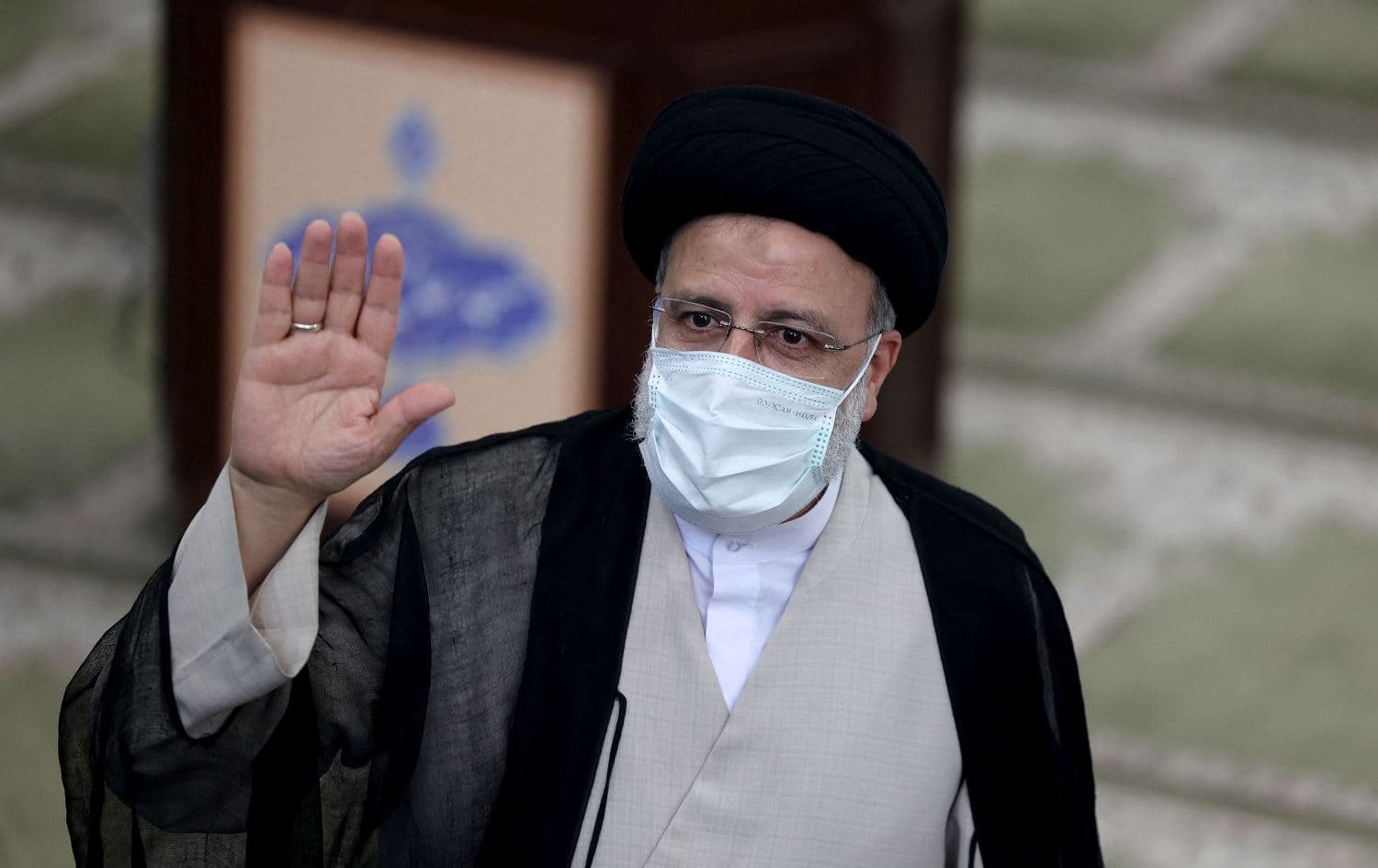 Ebrahim Raisi waves as he votes in Iran's presidential election at a polling station in Tehran on June 18, 2021. Photo: Atta Kenare/AFP