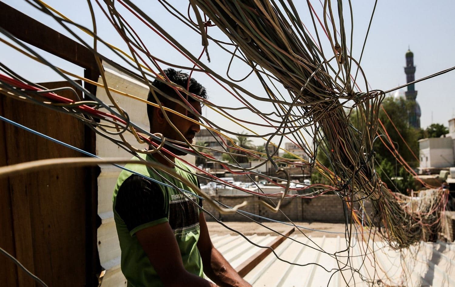 A man checks electrical wires in Baghdad. File photo: AFP/Sabah Arar