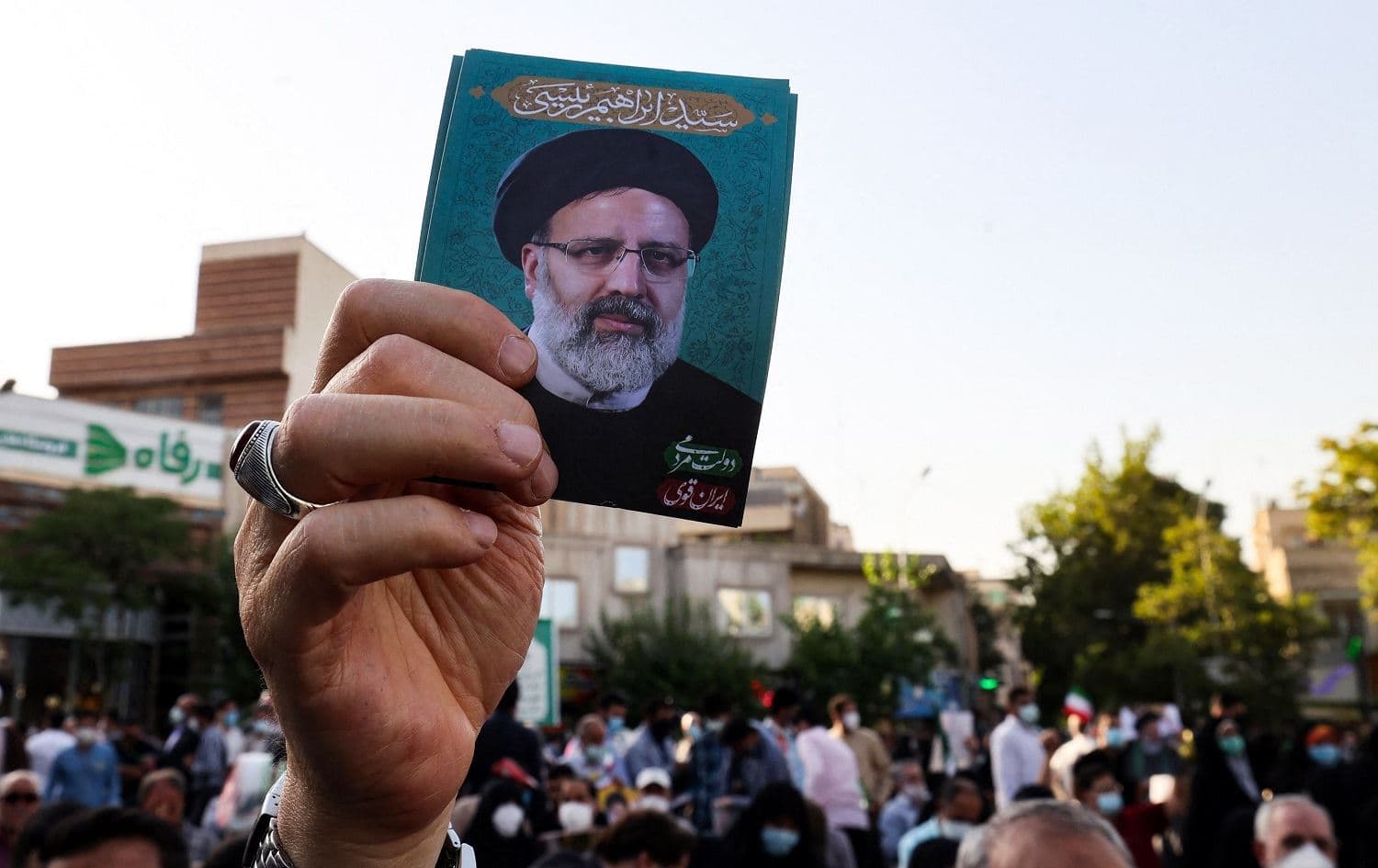 A supporter of Ebrahiam Raisi raises his portrait during an election rally in Tehran on June 16, 2021. File photo: Atta Kenare/AFP
