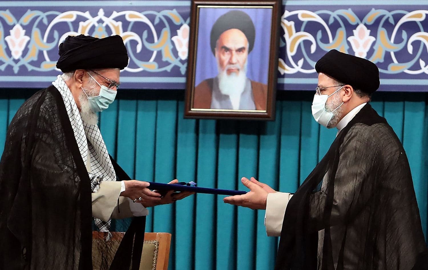 Iran's Supreme Leader Ayatollah Ali Khamenei (left) endorses the presidency of Ebrahim Raisi (right) in a ceremony in Tehran on August 3, 2021. Photo: handout/Khamenei.ir/AFP