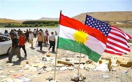 The US and Kurdistan flags fly alongside on Kurdish soil. 