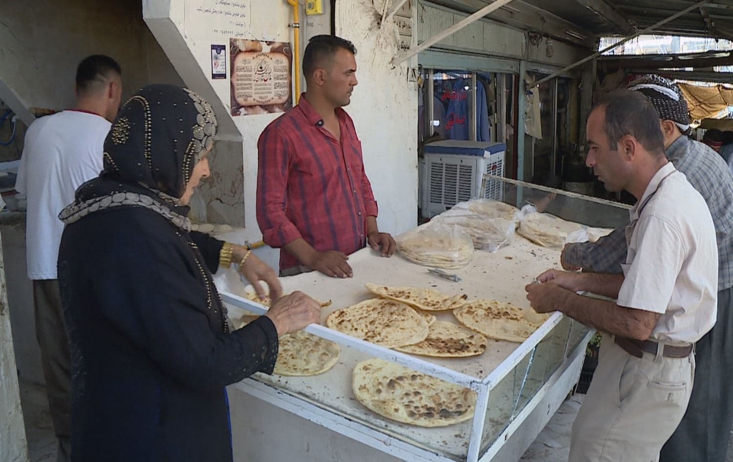 People buy bread at a bakery in Sulaimani. Photo: Rudaw