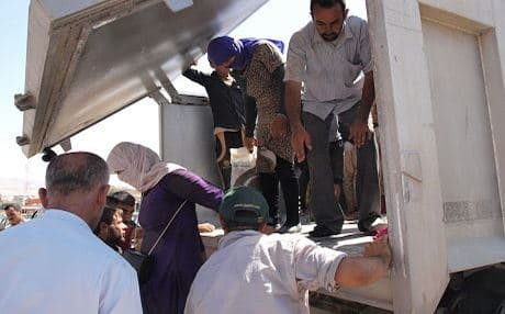 Refugees being helped off a truck arriving in Sharya. Photo by author.