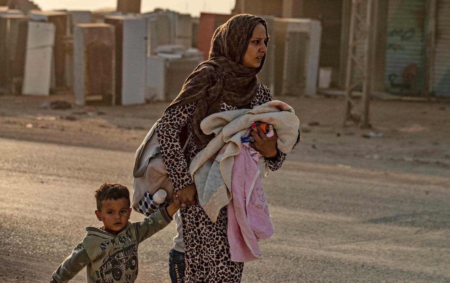 A mother and children displaced by an October 2019 Turkish offensive in northeastern Syria. File photo: Delil Souleiman/AFP