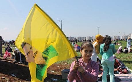 A young supporter waves a portrait of PKK leader Abdullah Ocalan during Newroz celebrations in Diyarbakir last March. Photo by author