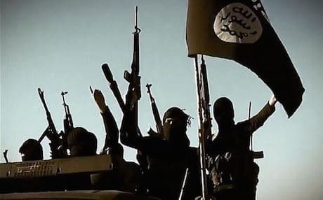 IS militants in Iraq pose with guns under their black flag. Photo: AFP