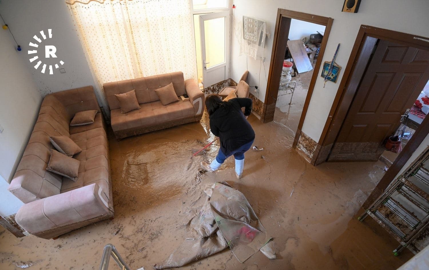 A woman cleans mud from her home after flooding in Erbil’s Zerin City on October 30, 2021. Photo: Bilind T. Abdullah/Rudaw