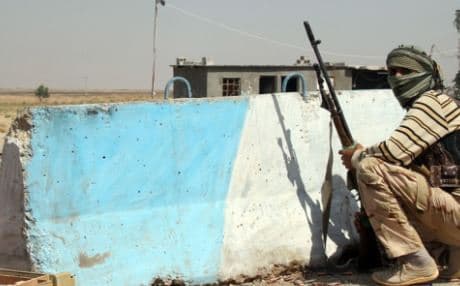 An Iraqi Turkmen Shiite fighter holds a position in Amerli in this AFP file photo from August 4.