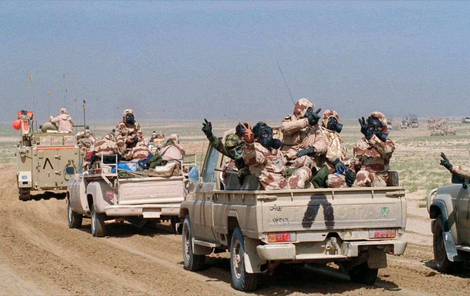 Kuwaiti troops wearing gas masks and protective suits in 1991. Photo: Laurent Rebours / AP