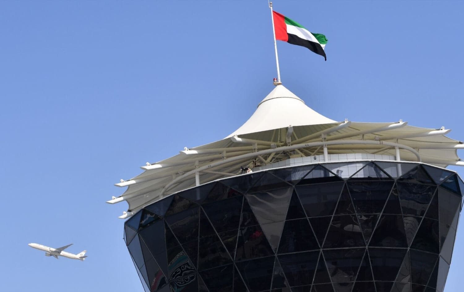 An Etihad Airways plane flies over the main control tower at the Yas Marina circuit ahead of the start of the Abu Dhabi Formula One Grand Prix on November 27, 2016. File photo: AFP
