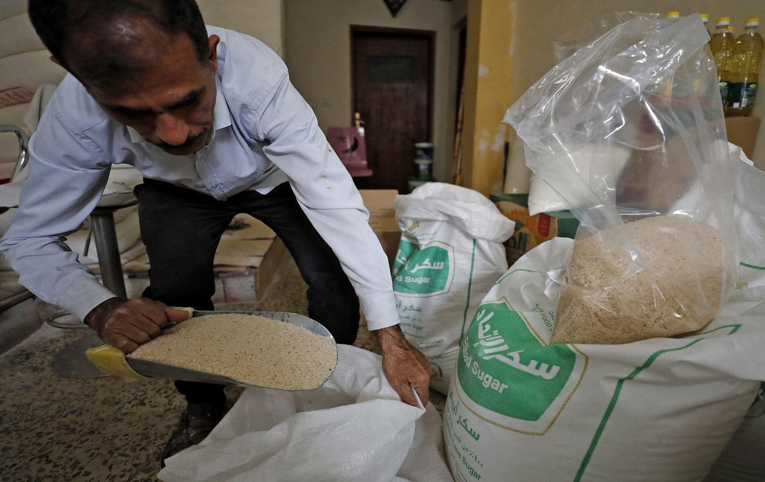 An Iraqi worker prepares food rations to be distributed to people in need at his warehouse in Baghdad’s Karrada district on April 7, 2021. Photo: Ahmad al-Rubaye/AFP