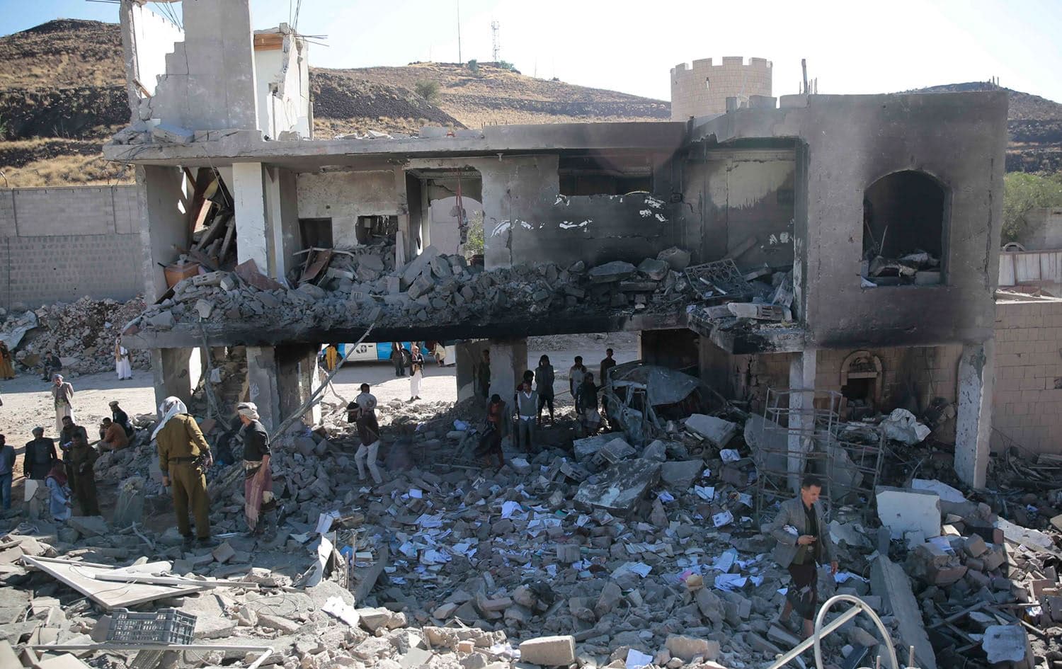 People inspect a damaged building at the site of a Saudi-led airstrike on Sanaa, Yemen, in January, 2022. Photo: AP