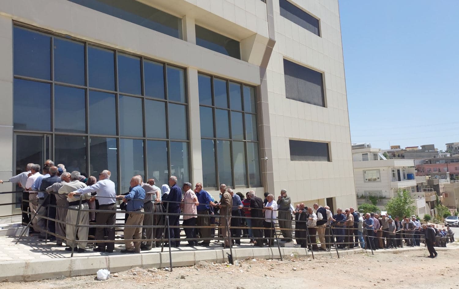 Pensioners queue in front of a bank in Sulaimani city on Saturday to receive their delayed salaries on April 23, 2022. Photo: Nizar Jaza/Rudaw