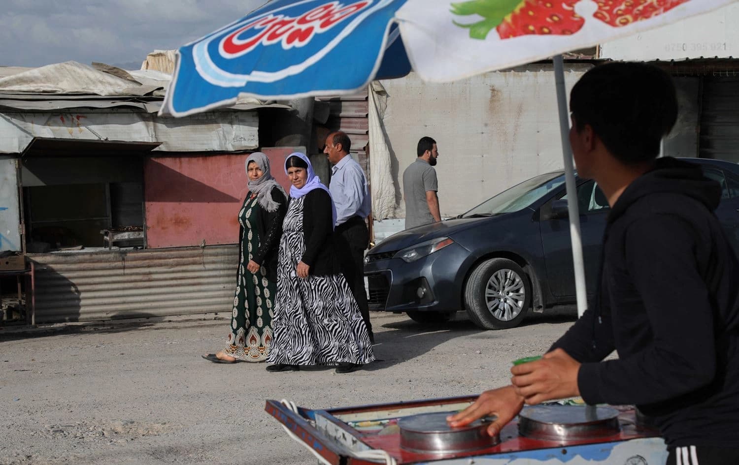Displaced Yazidi women walk in the Chamishko camp for internally displaced persons (IDPs) in the Kurdistan Region's Zakho, on May 5, 2022. Photo: AFP