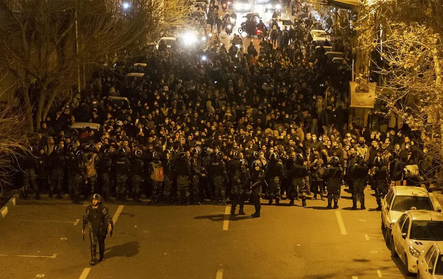 Iranian riot police stand guard as protesters gather in front of Tehran's Amir Kabir University in 2019. Photo: AFP