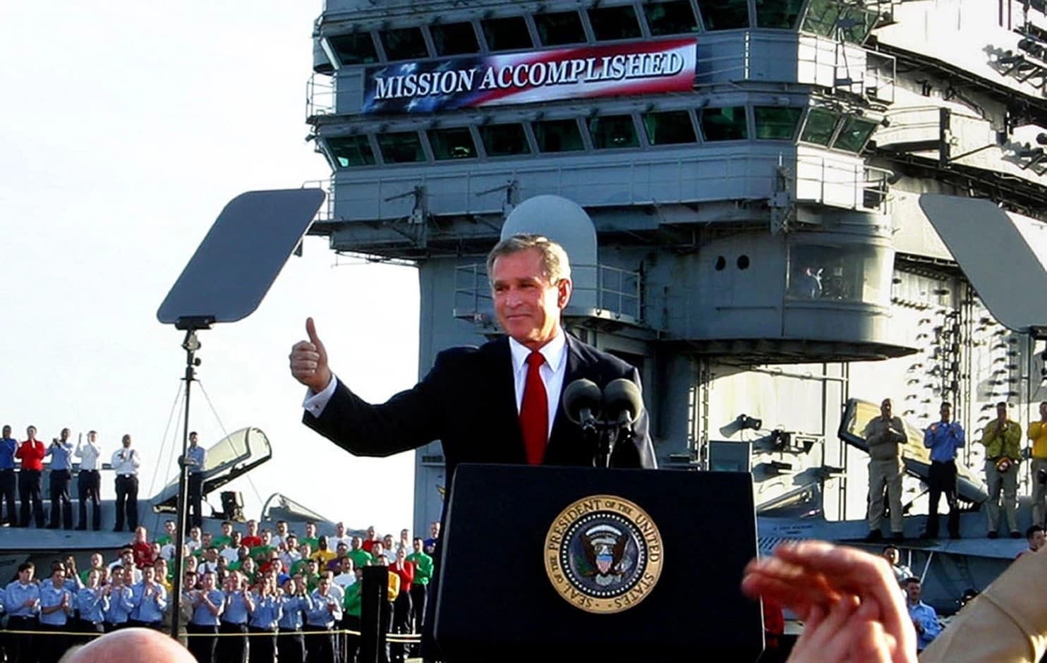 President Bush flashes a "thumbs-up" after declaring the end of major combat in Iraq as he speaks aboard the aircraft carrier USS Abraham Lincoln off the California coast, May 1, 2003. Photo: Scott Applewhite/AP
