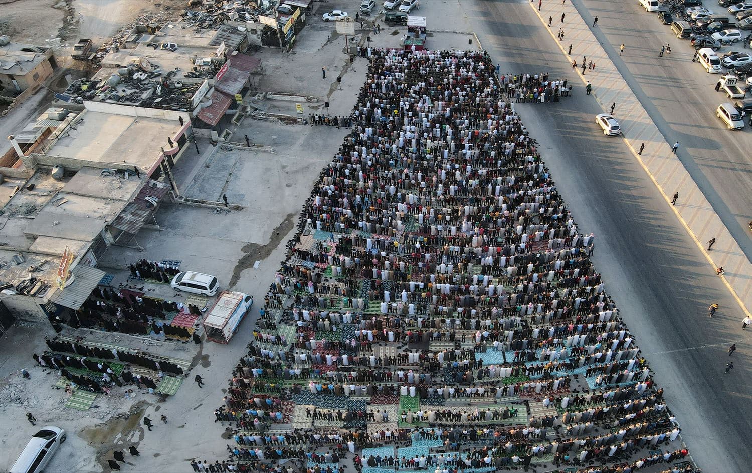 Aerial view showing Muslims performing Eid al-Adha prayer in Bab al-Hawa in Idlib province on July 9, 2022. Photo: Aaref Watad/AFP