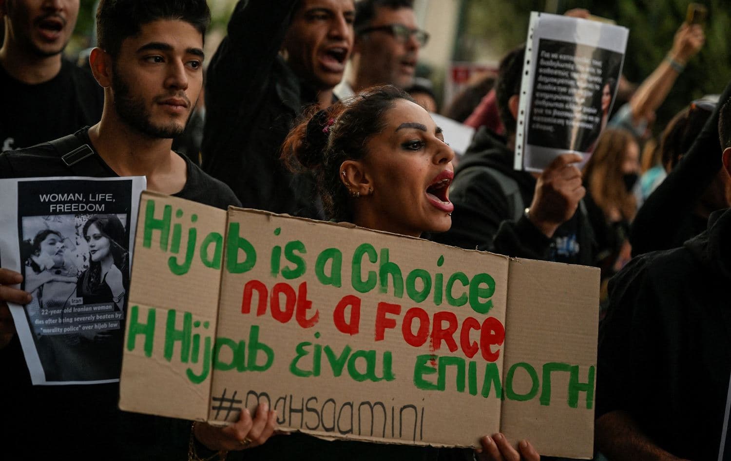 A protester holds a placard during a demonstration by Iranians living in Greece in central Athens on September 24, 2022. Photo: Louisa Gouliamaki/AFP