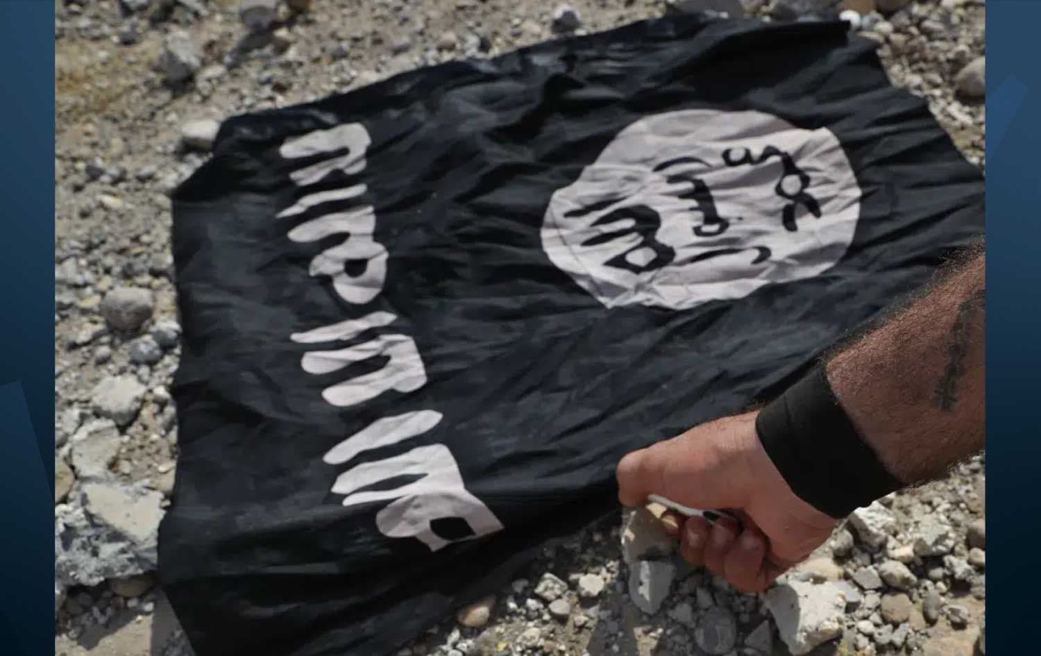 A fighter from the Kurdish-led SDF, burns an ISIS flag in Raqqa, northeast Syria. Date: July 17, 2017. Photo: AP