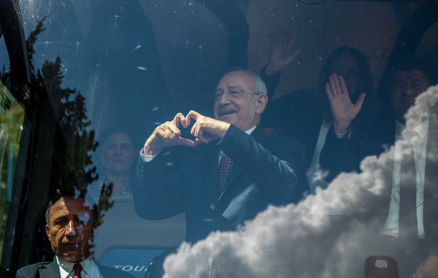 Kemal Kilicdaroglu, chairman of the Republican People's Party (CHP) and presidential candidate, gestures a heart from inside a campaign bus during his visit to Adiyaman on April 21, 2023. Photo: Bulent Kilic/AFP