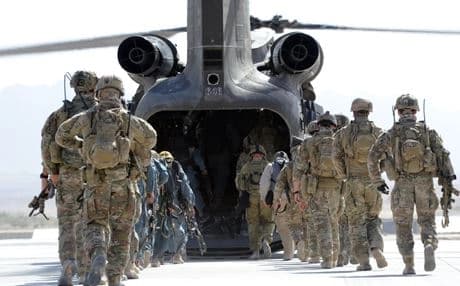 Australian special forces wait for legal protection from Baghdad before deploying to Iraq.