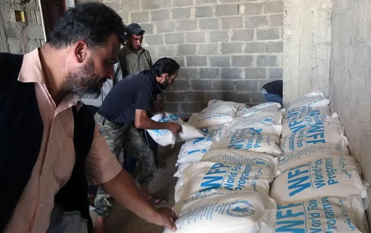 Aid packages from the United Nations and the Syrian Arab Red Crescent (SARC) being delivered to locals in eastern Ghouta. Photo: Amer Almohibany/AFP