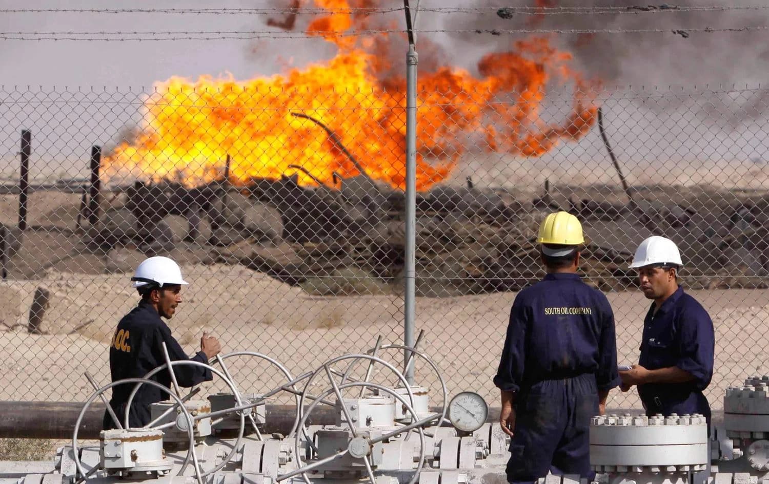 Workers at an oil refinery in Basra, Iraq. File photo: Nabil Al-Jourani/AP