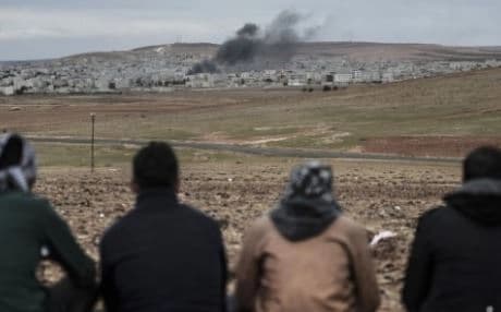 Kurds watch the Syrian town of Kobane from Turkey. Photo: AFP. 