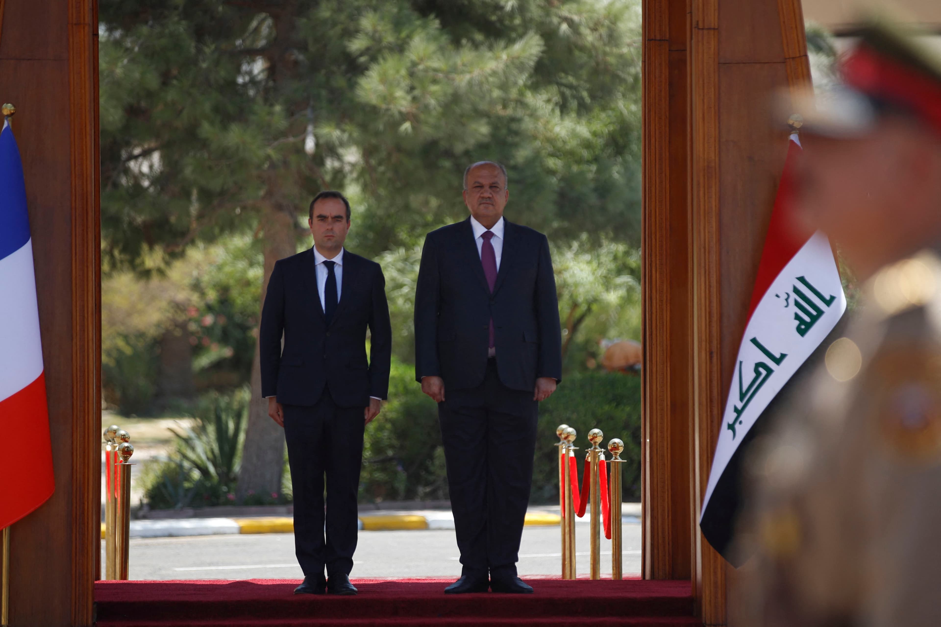 Iraq's Defence Minister Thabet al-Abbassi (R) welcomes France's Minister of the Armed Forces Sebastien Lecornu in Baghdad, on July 18, 2023. Photo: AFP