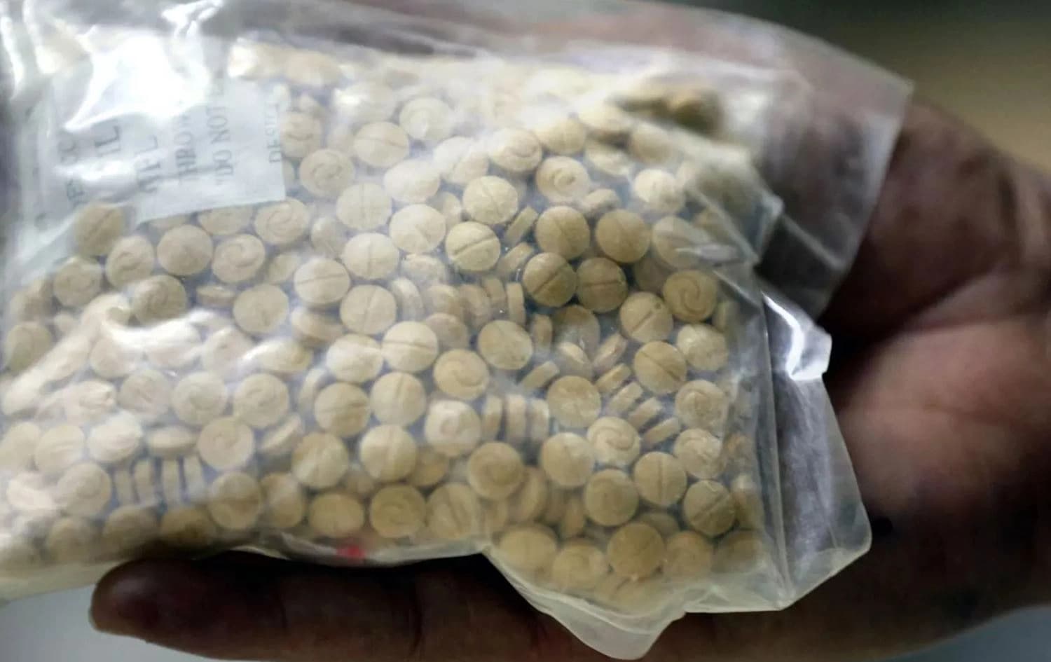 A bag of pills is displayed at the police anti-narcotics unit headquarters in Amman on 7 January 2019 (AFP)