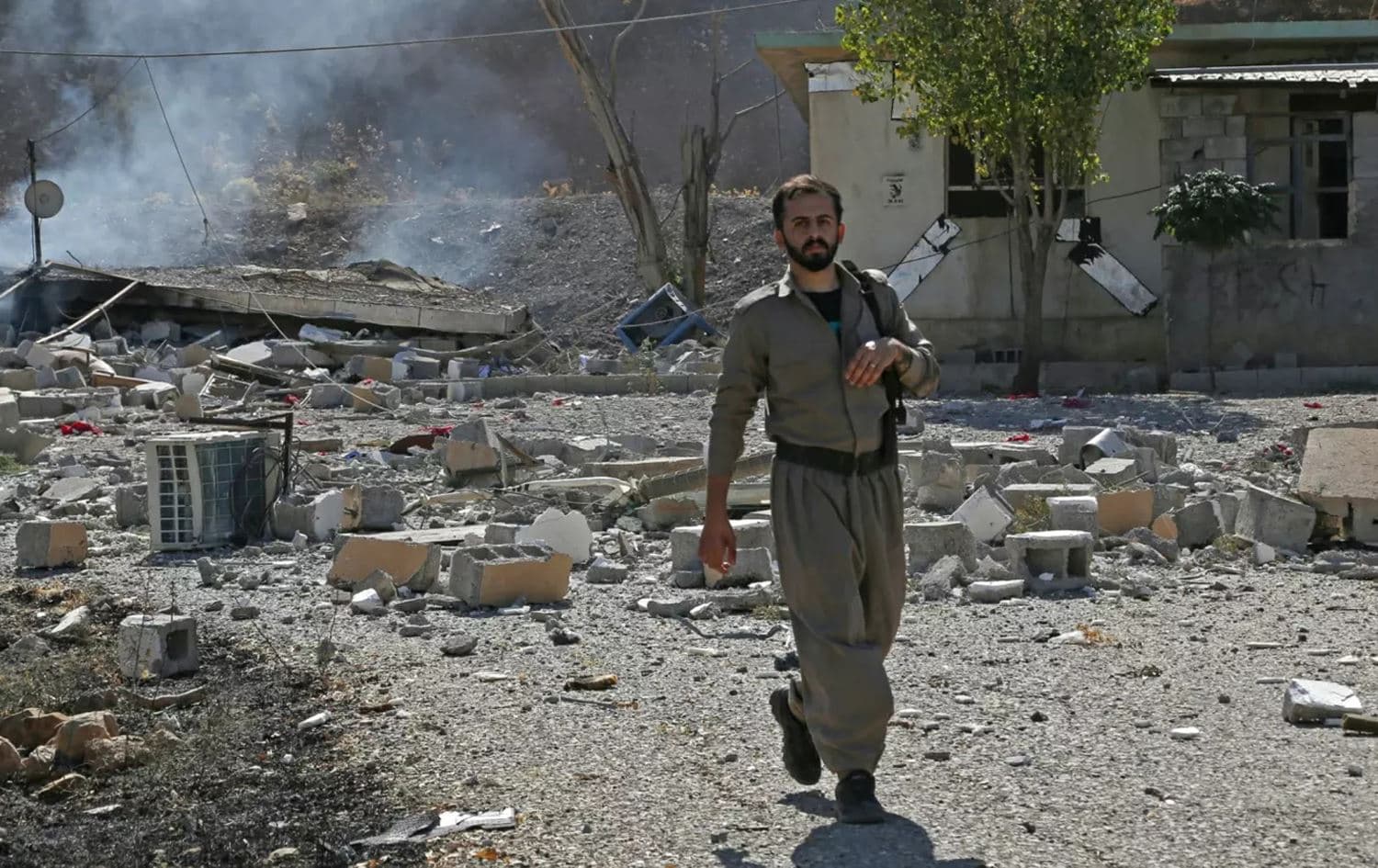 A Kurdish opposition fighter inspects the damage following an Iranian cross-border attack on an exiled group’s headquarters in Sulaimani's Zirgwez region on September 28, 2022. Photo: AFP