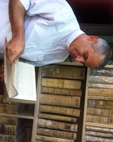 Father Nageeb in the safe house where he has stored a collection of ancient manuscripts. Photo: Author