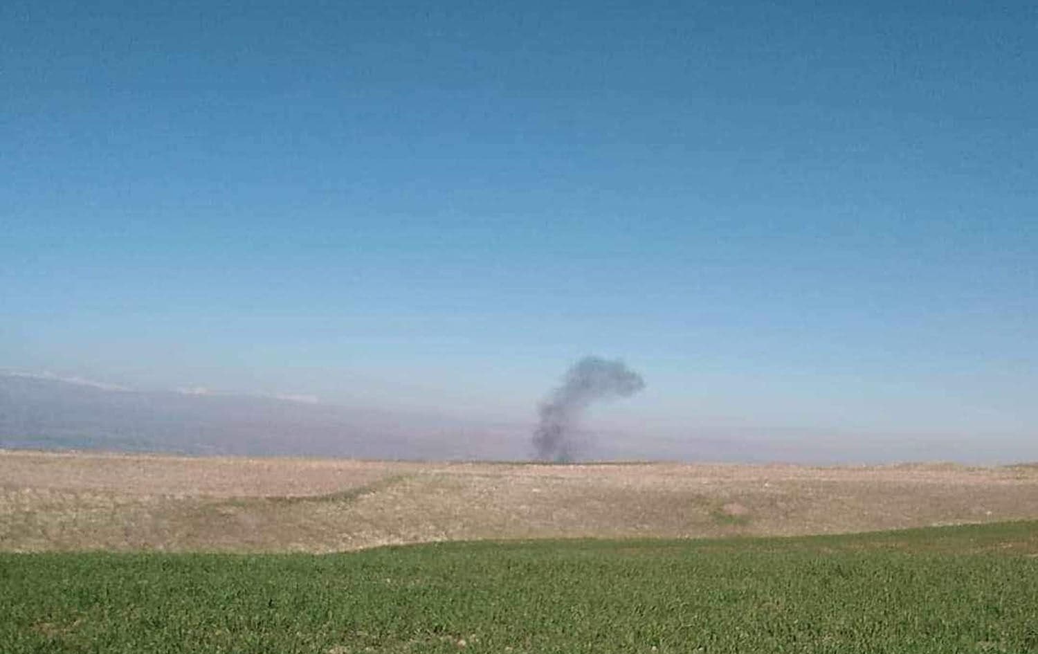 Smoke rising where a suspected Turkish drone targeted Chamchamal’s Aghjalar subdistrict on December 27, 2023. Photo: Submitted