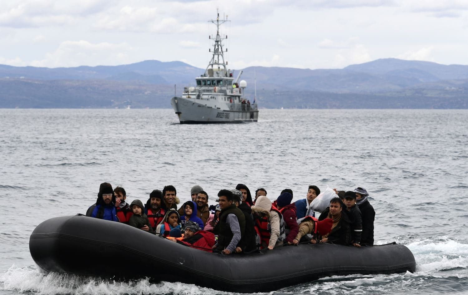 Migrants in a dinghy accompanied by a Frontex vessel on the Greek island of Lesbos, after crossing the Aegean Sea from Turkey on February 28, 2021. Photo: AFP
