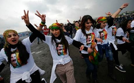 Supporters of the Kurdistan Workers Party (PKK) dance in T-shirts adorned with images of the groups imprisoned leader Abdullah Ocalan. Photo: Rudaw
