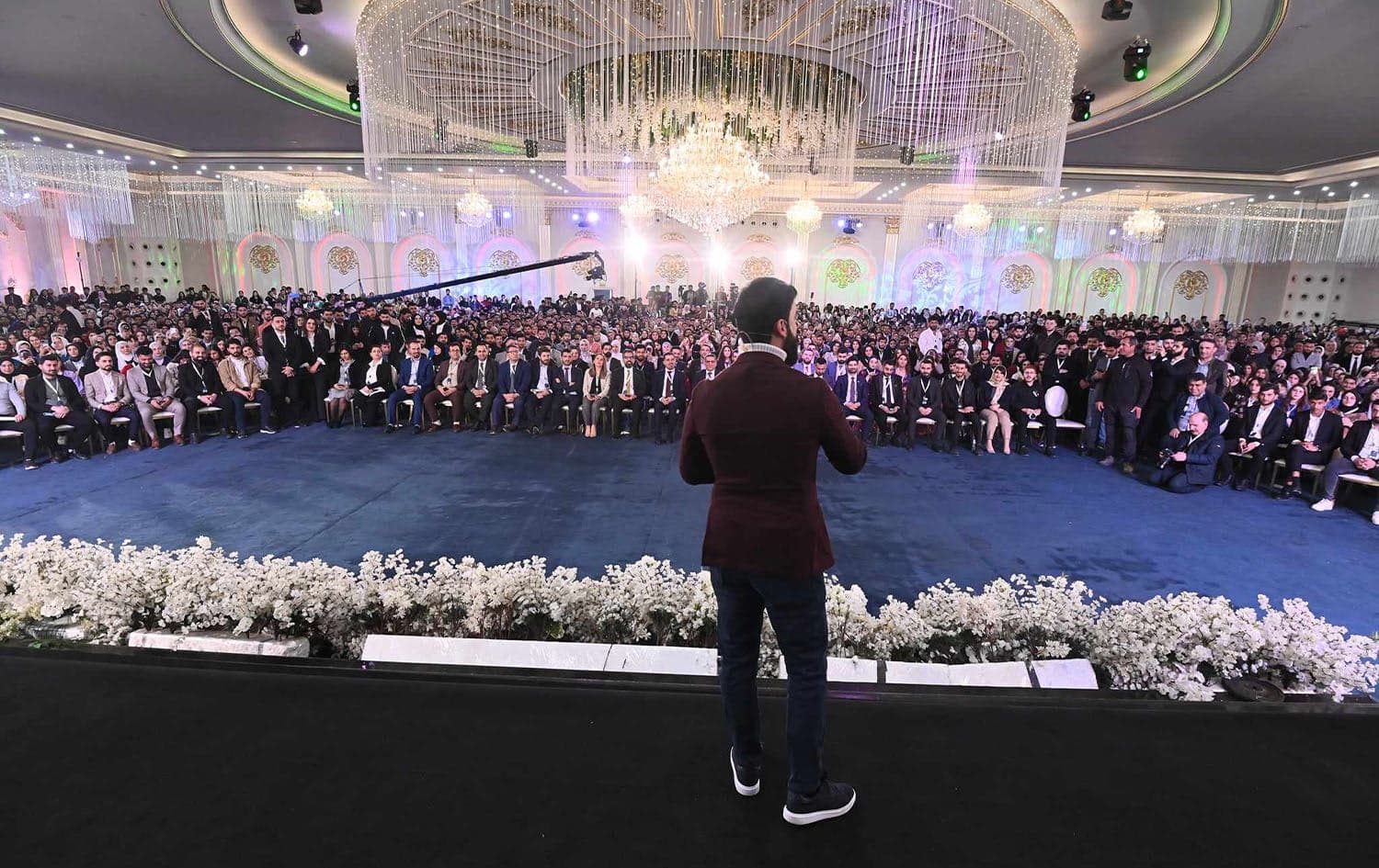Dr. Aras Bradosty (center) delivering a speech during the Dr. Aras Community program in Erbil on February 28, 2024. Photo: Bilind T. Abdullah/Rudaw