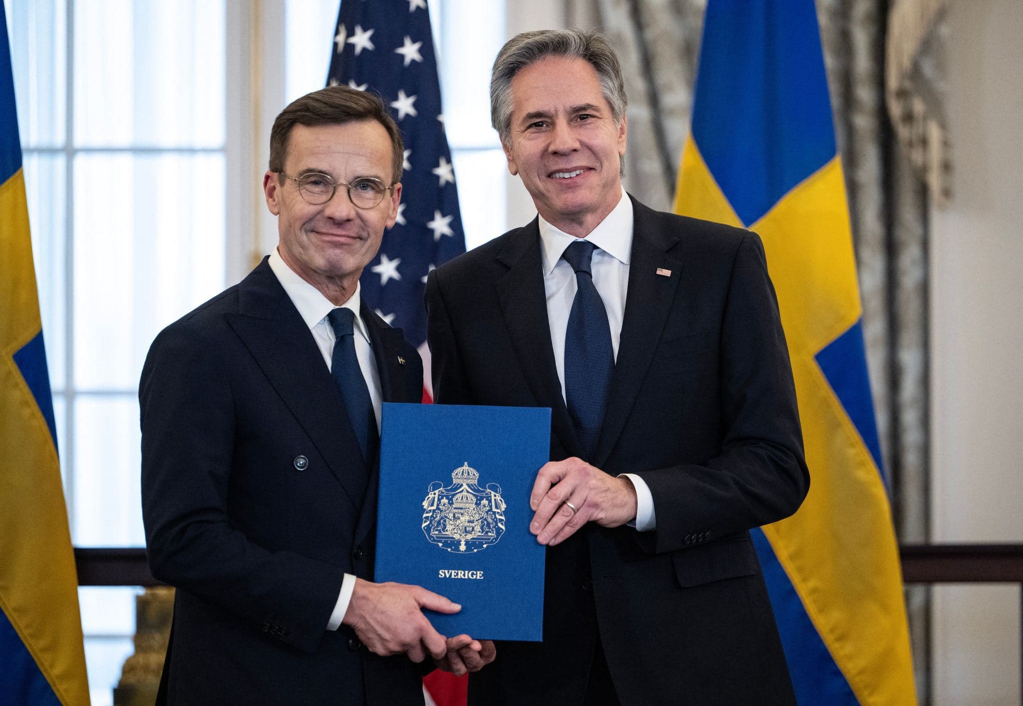 US Secretary of State Antony Blinken (right) receives the NATO ratification documents from Swedish Prime Minister Ulf Kristersson (left) during a ceremony in Washington on March 7, 2024. Photo: AFP