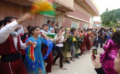 Kurdish men and women celebrate the inauguration of the Muhammed Shexo Culural Center in the city of Qamishli. Photo: PYD Facebook