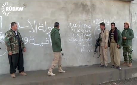 Kurdish Peshmerga forces inspecting a captured ISIS base near Makhmour.