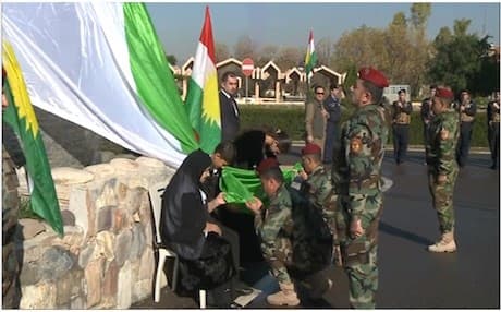 Peshmerga soldiers honoring Flag Day in Kurdistan. 