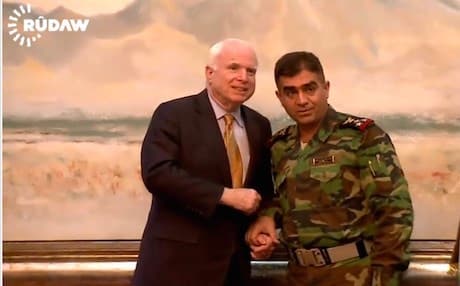 McCain poses with a Peshmerga commander. 
