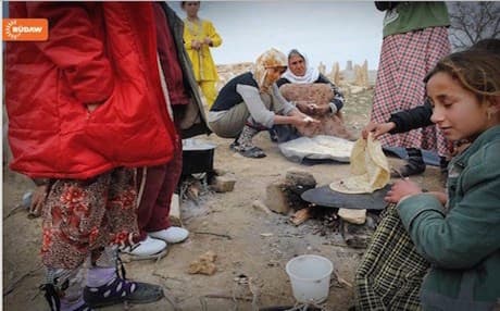 Yezidi women baking bread on Mount Shingal.