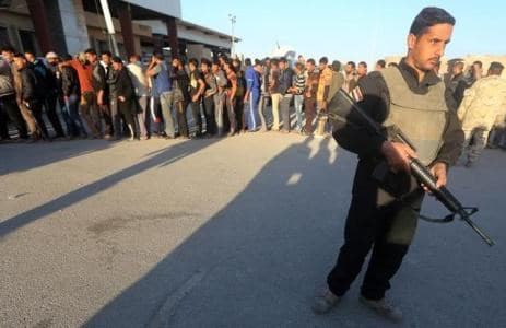 AFP file photo of Sunni volunteers lining up for training at the al-Assad air base last November. 