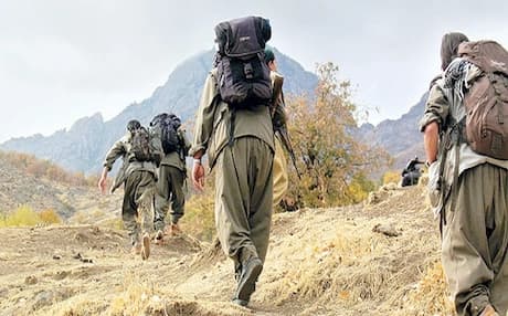 PKK fighters walk into the Qandil Mountains as they withdraw from Turkey as part of a peace deal agreed on between Ankara and Abdullah Ocalan. Photo: AP