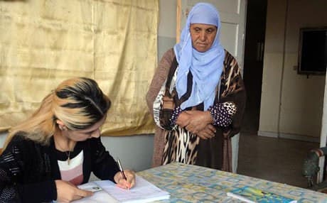 A woman registers to vote in the canton of Cizire. Rudaw photo.