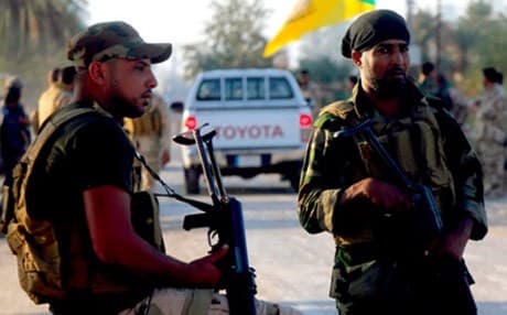 Shiite fighters guard a checkpoint south of Baghdad. Reuters file photo