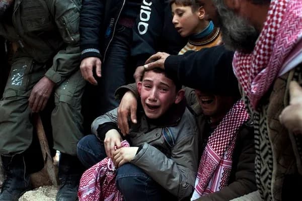 A boy name Ahmed mourns for his father, who was killed by a Syrian army sniper. Photo: AP.