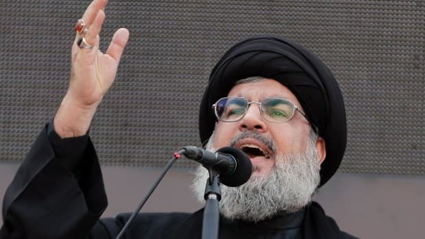 Hezbollah leader Sheik Hassan Nasrallah, speaks to the crowd in a rare public appearance during Ashura, which marks the death of Shiite Islam's Imam Hussein, in the suburbs of Beirut, Lebanon, Thursday, Nov. 14, 2013. Photo: AP.
