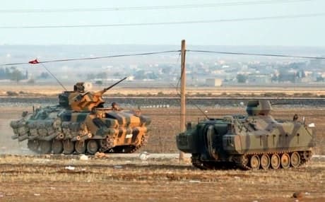 A Turkish tank and armored vehicle near the border with Syria. AP file photo.